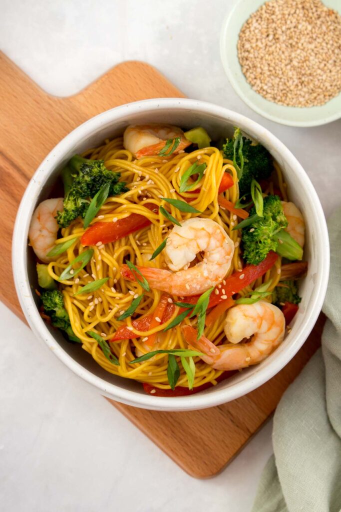 A bowl of shrimp stir fry noodles.