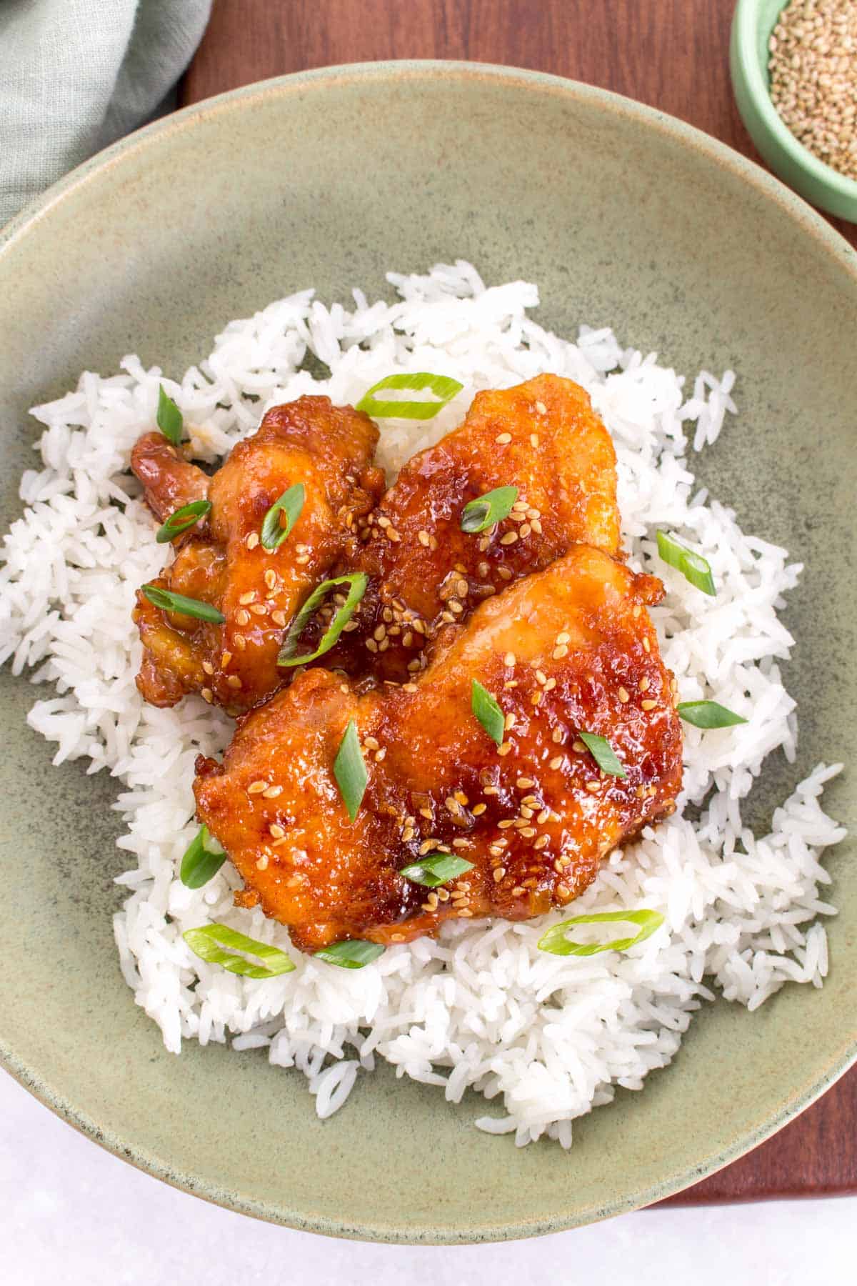 A plate with rice and honey sesame chicken.