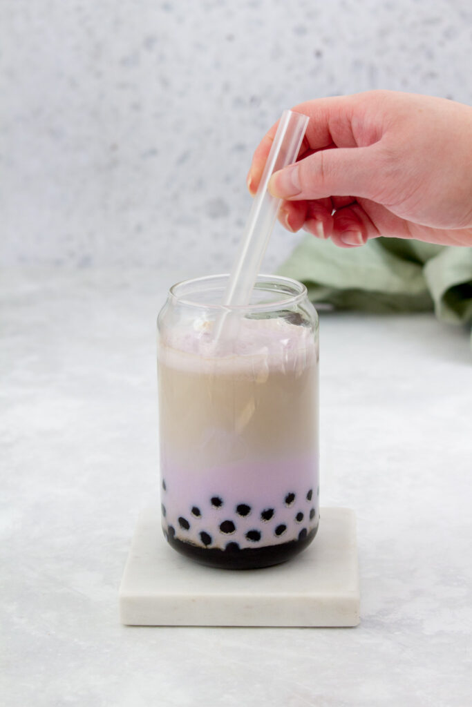 Taro milk tea being stirred.