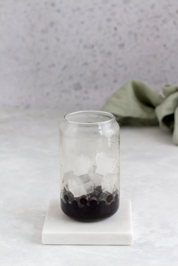 Glass with tapioca with brown sugar syrup and ice.