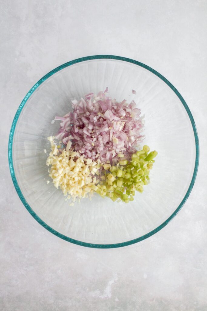 Minced shallots, lemongrass, and garlic in a bowl.