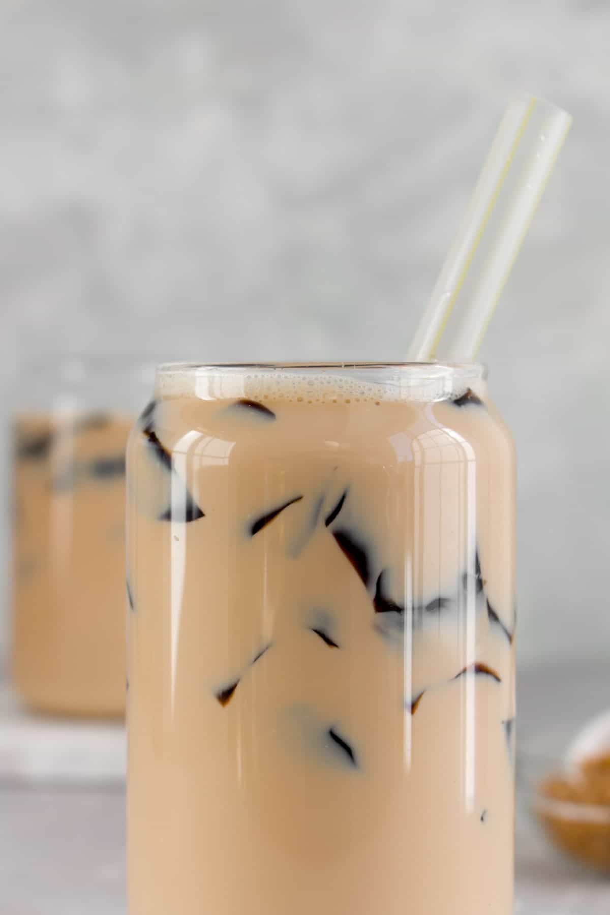 Close up of a grass jelly milk tea with a straw.