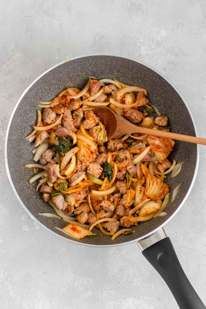 Pan of kimchi udon ingredients stir fried.