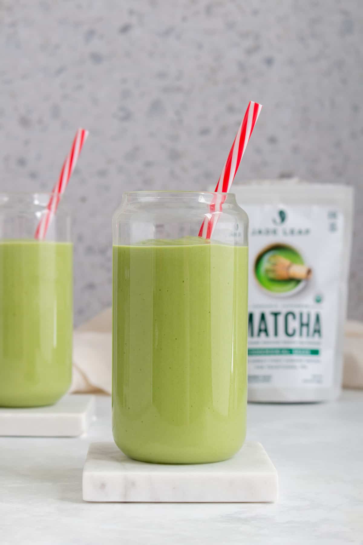 Two glasses of matcha avocado smoothies.