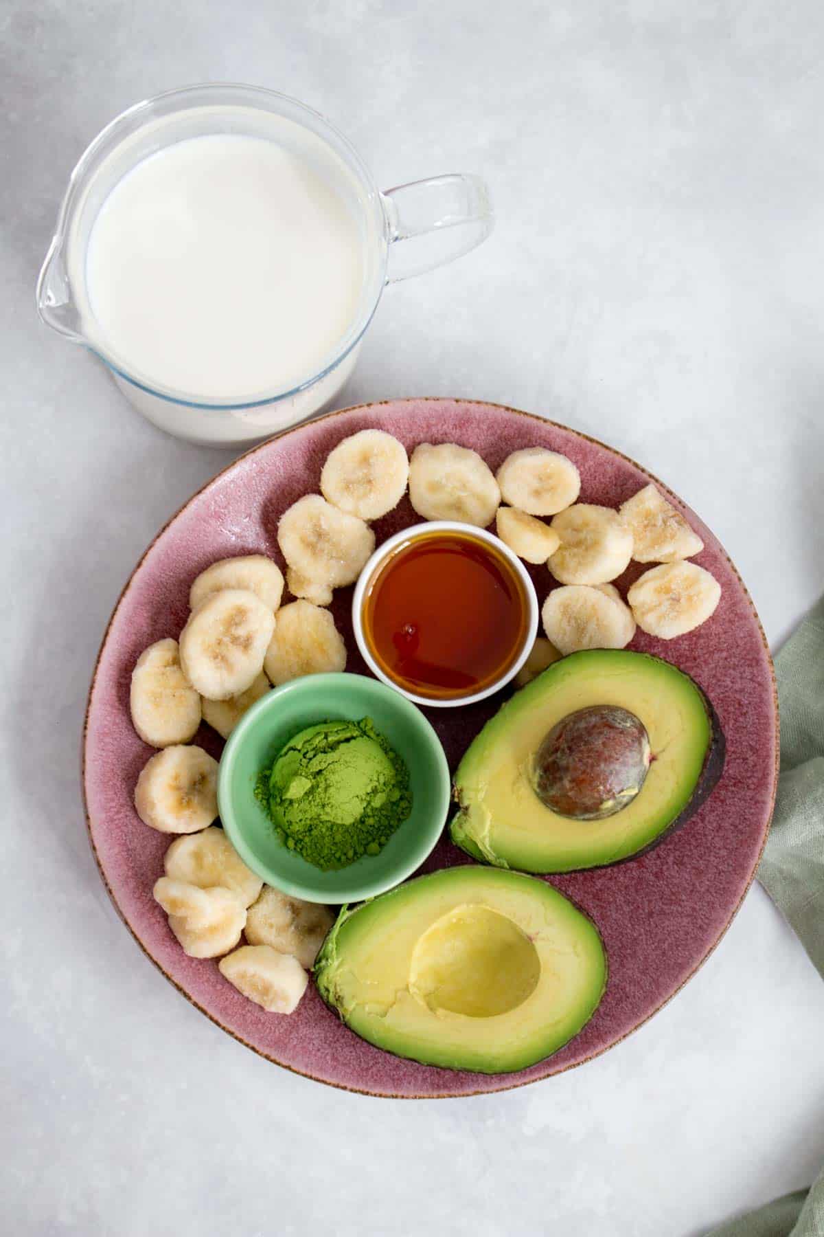 Ingredients to make a matcha avocado smoothie.