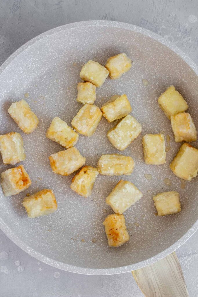 Pan with pan fried tofu cubes.