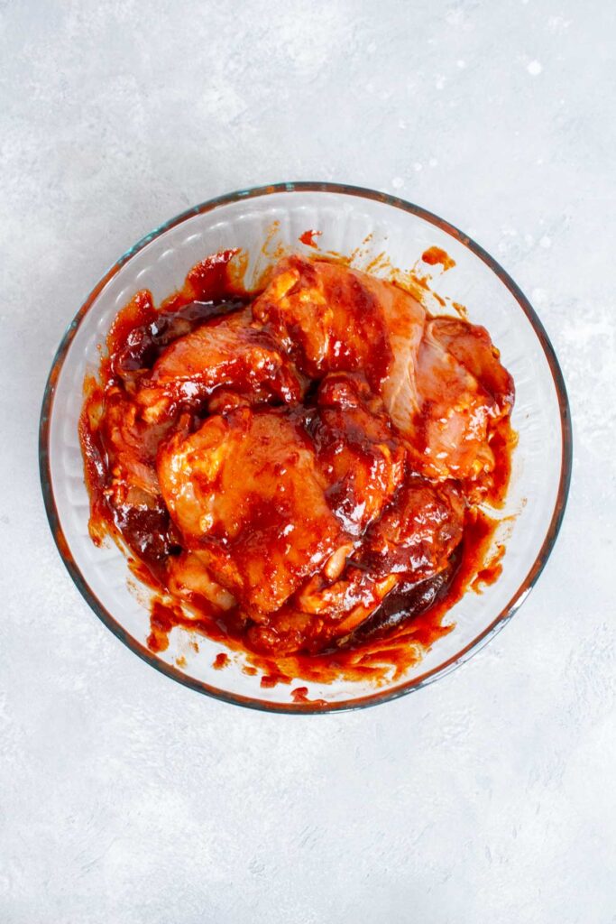 Chicken thighs coated in gochujang sauce.