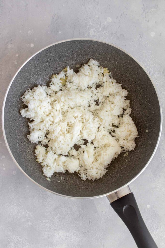 Rice added to a pan.