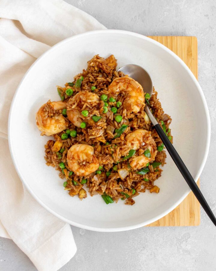 A plate with shrimp fried rice.