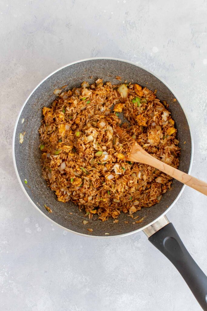 Fried rice combined in a skillet.