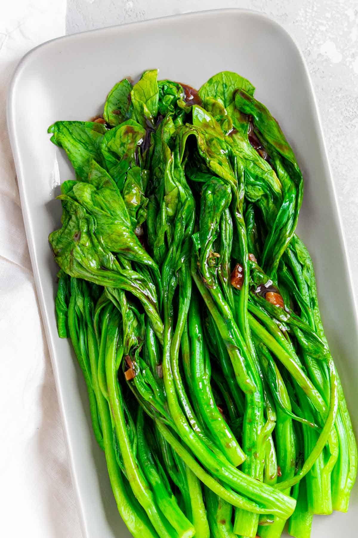 A platter of yu choy with garlic oyster sauce.