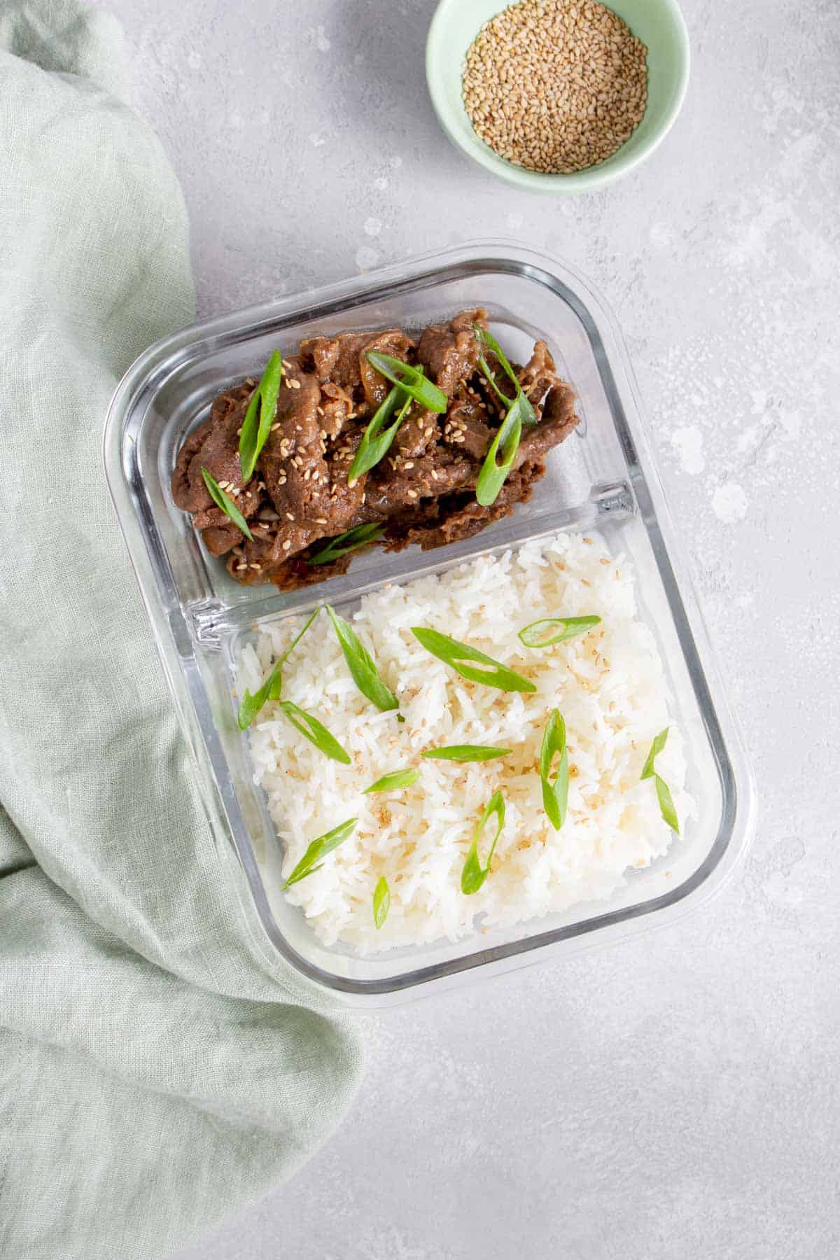 Meal prep container with beef teriyaki and rice.