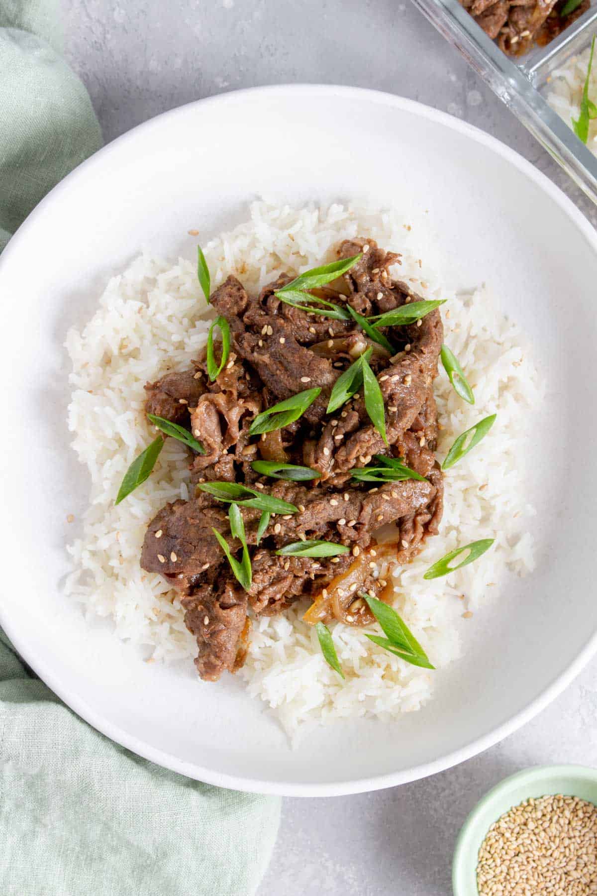 Close up of a plate of beef teriyaki over rice.
