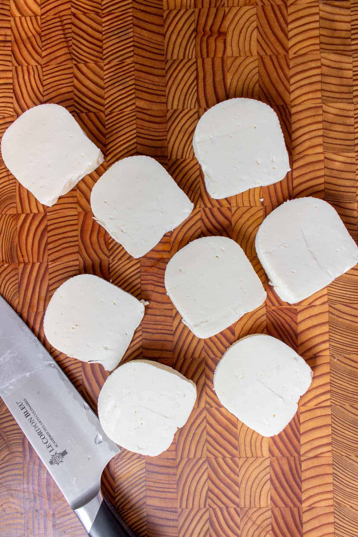 Sliced halloumi on a cutting board.