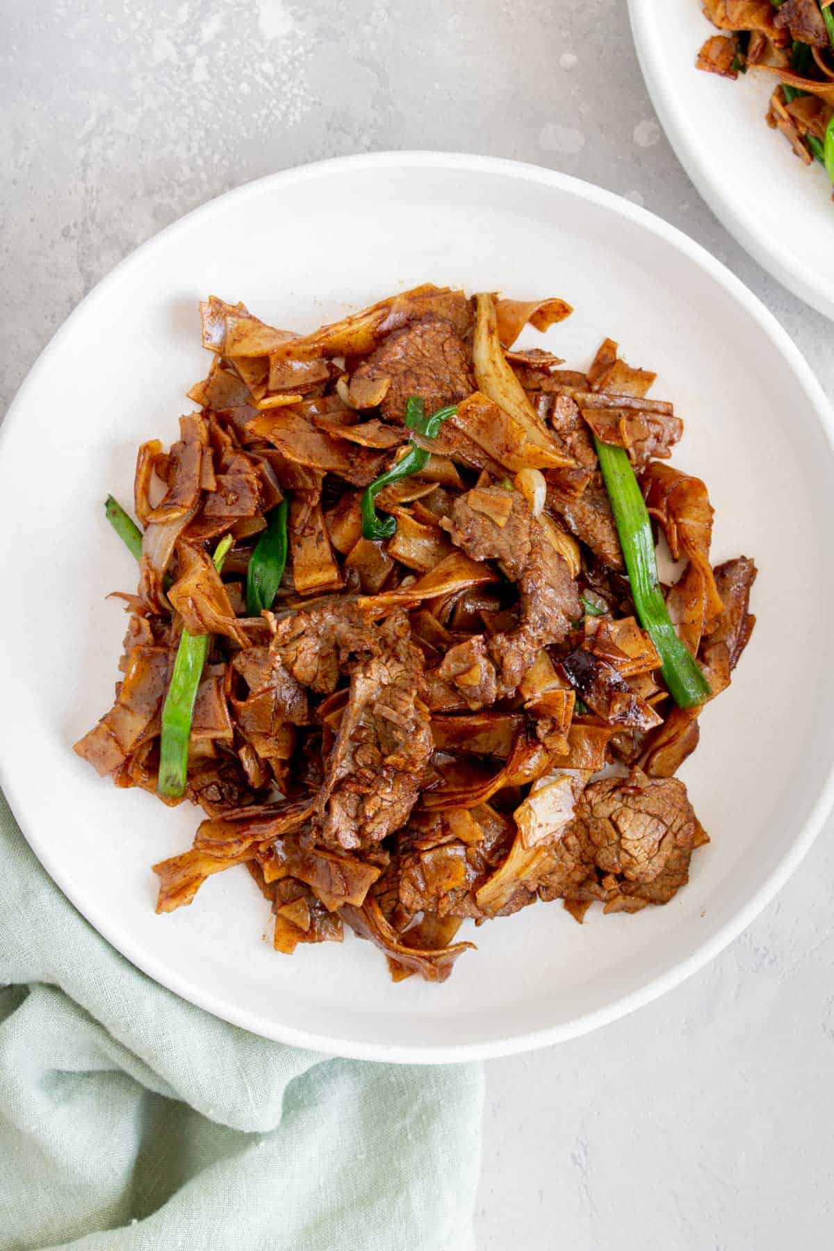 Close up of a plate of beef chow fun.