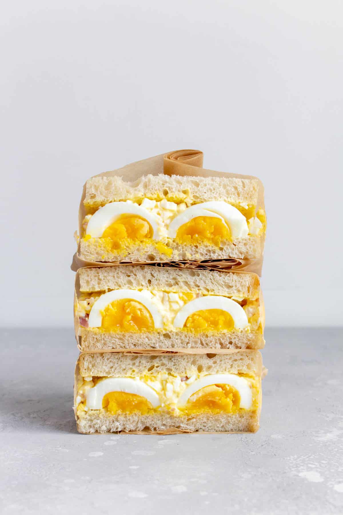 A stack of three Japanese egg salad sandwiches.
