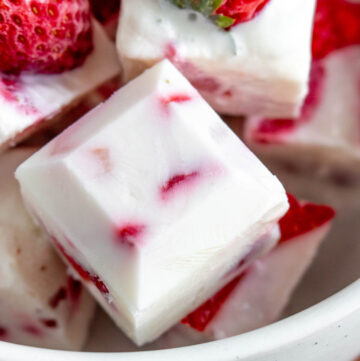 Frozen yogurt cube with strawberry chunks.