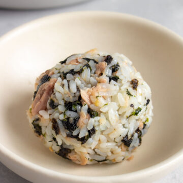 A plate with a single tuna mayo rice ball.