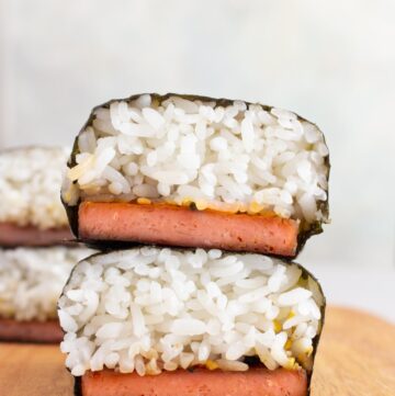 Two pieces of spam musubi stacked on top of each other.