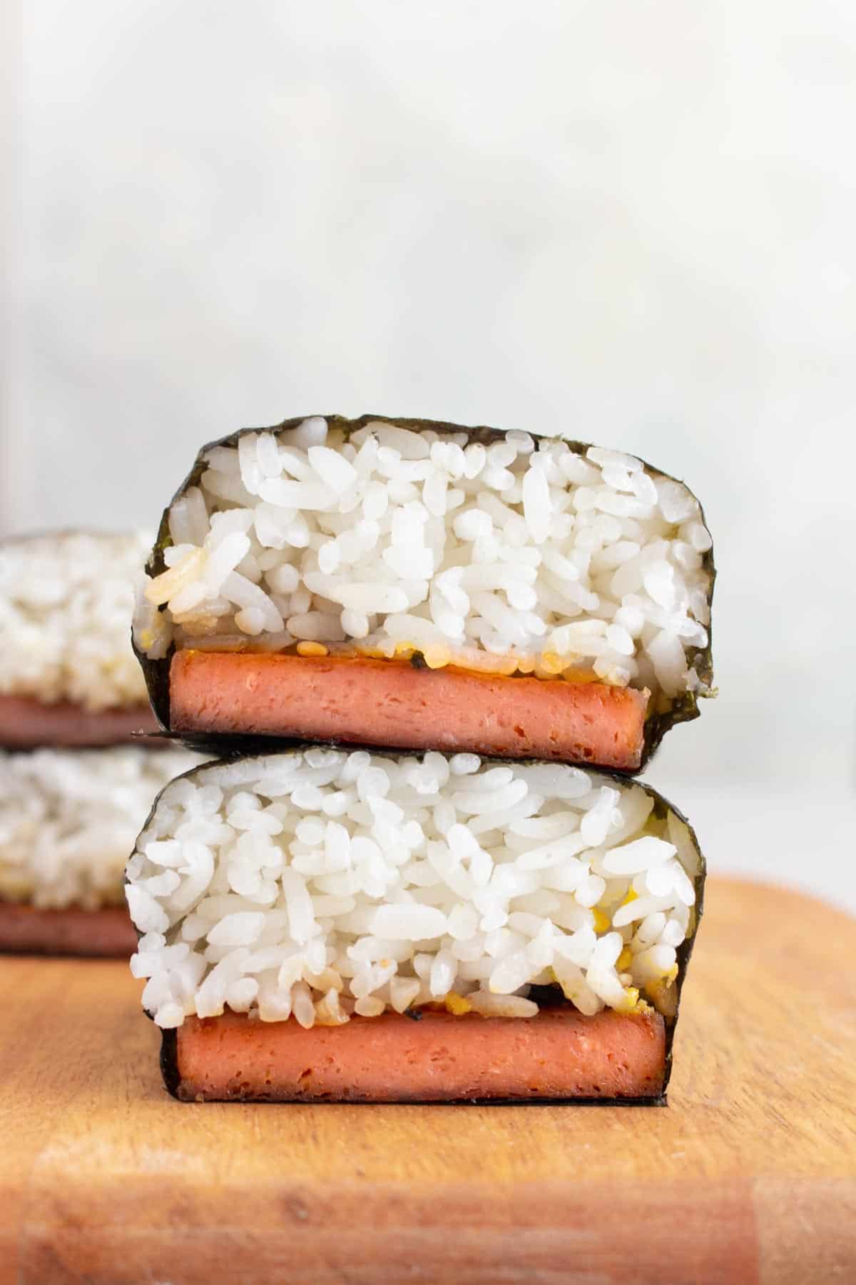 Two pieces of spam musubi stacked on top of each other.