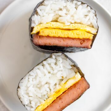 Two pieces of spam musubi with egg, one with two layers of egg.