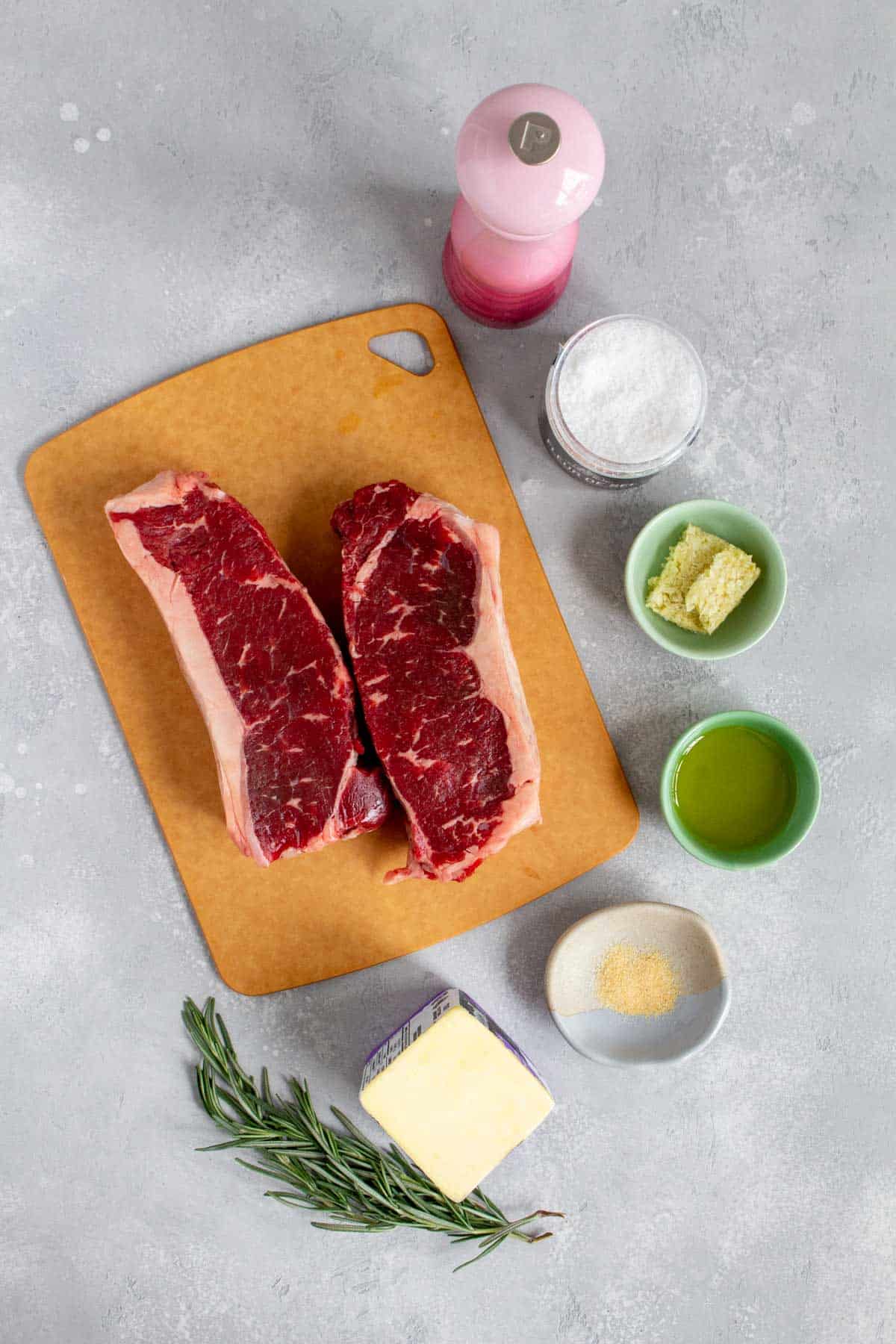 Overhead view of ingredients needed to make garlic butter steak.