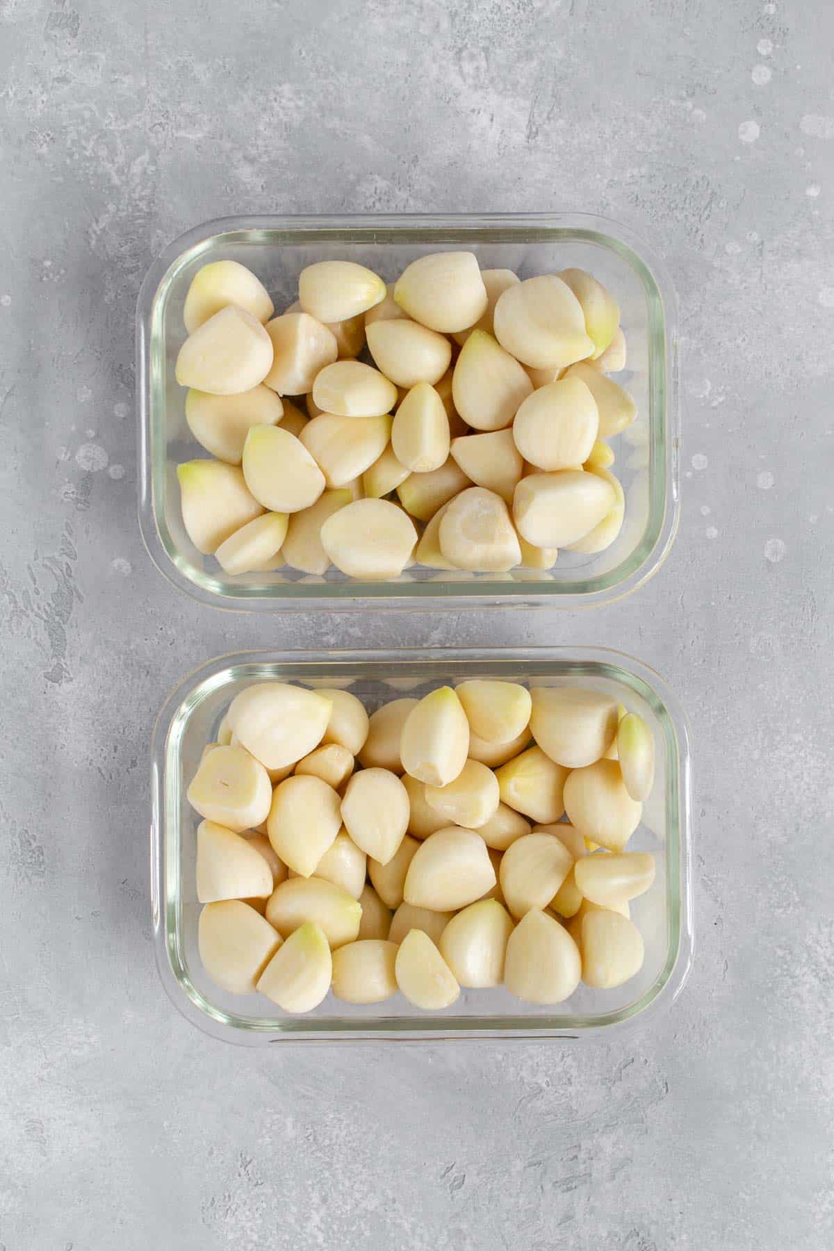 Two containers of frozen garlic cloves.