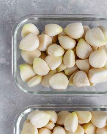 Two containers of frozen garlic cloves.