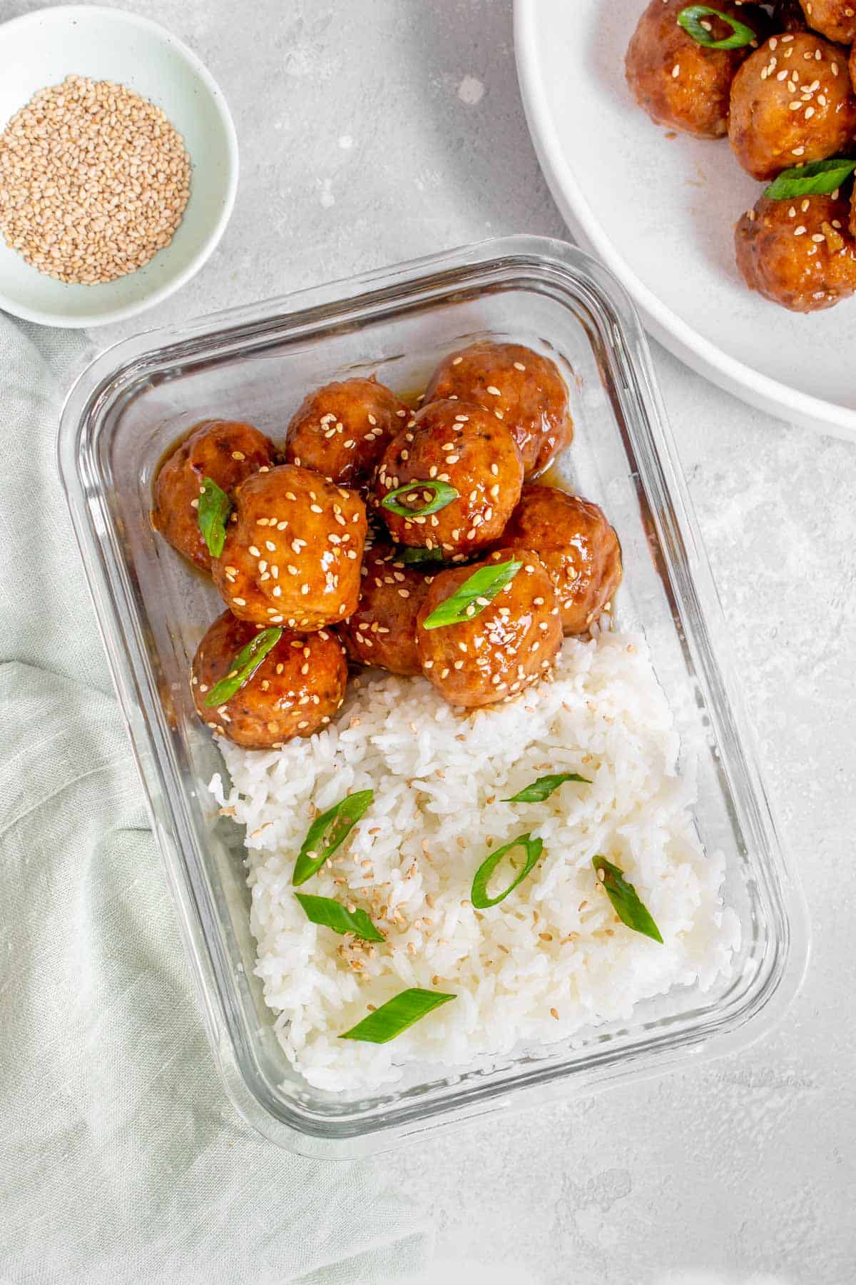 Overhead view of a meal prep container with rice and teriyaki turkey meatballs,