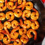 Overhead view of pan seared shrimp in a staub cast iron.