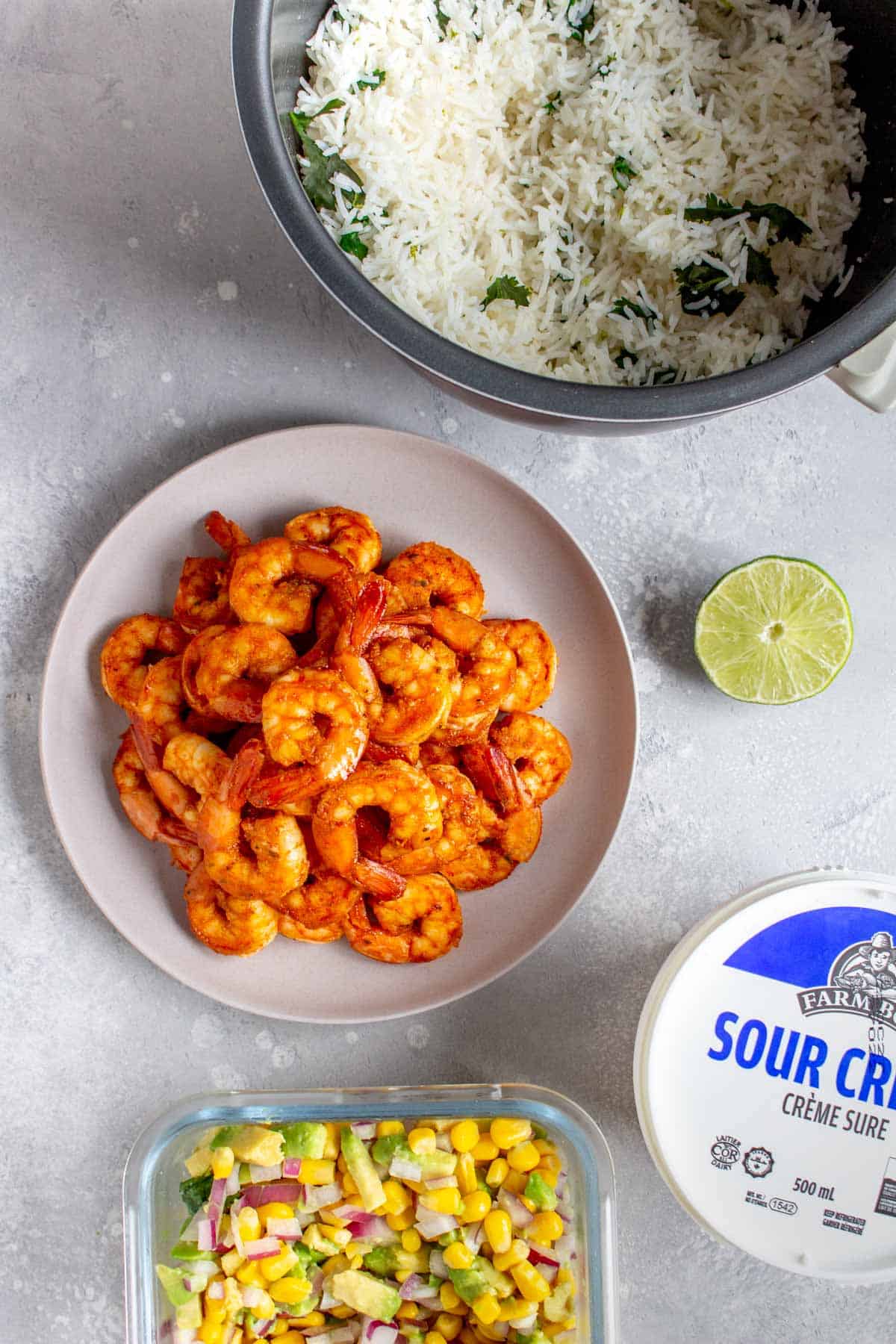 Ingredients needed to make a shrimp burrito bowl.