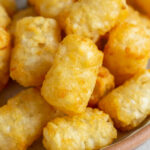 Close up of air fryer tater tots on a plate.