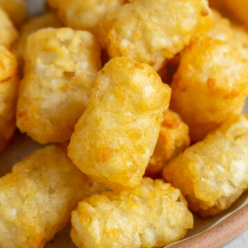 Close up of air fryer tater tots on a plate.