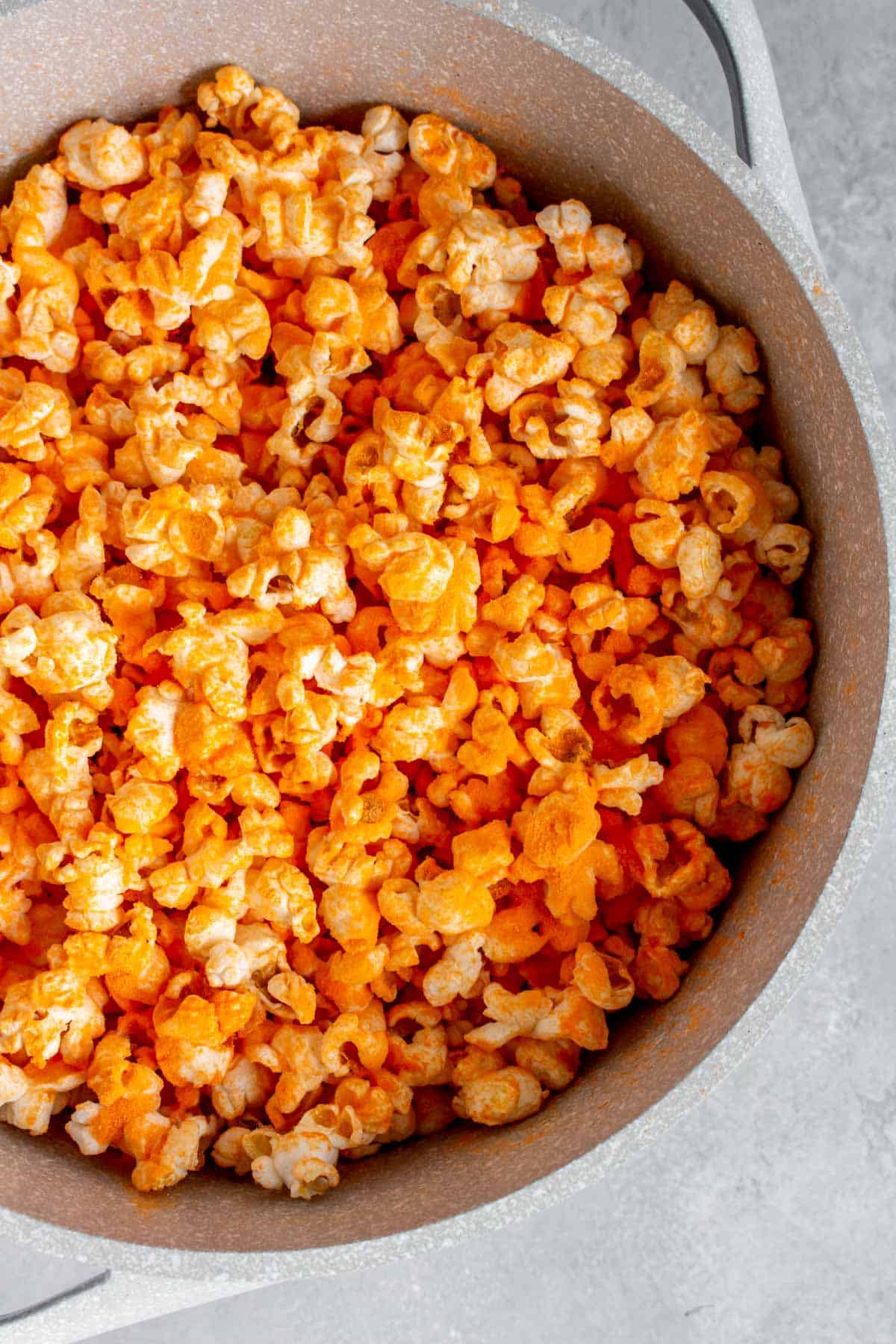 Overhead view of a pot of cheddar popcorn.