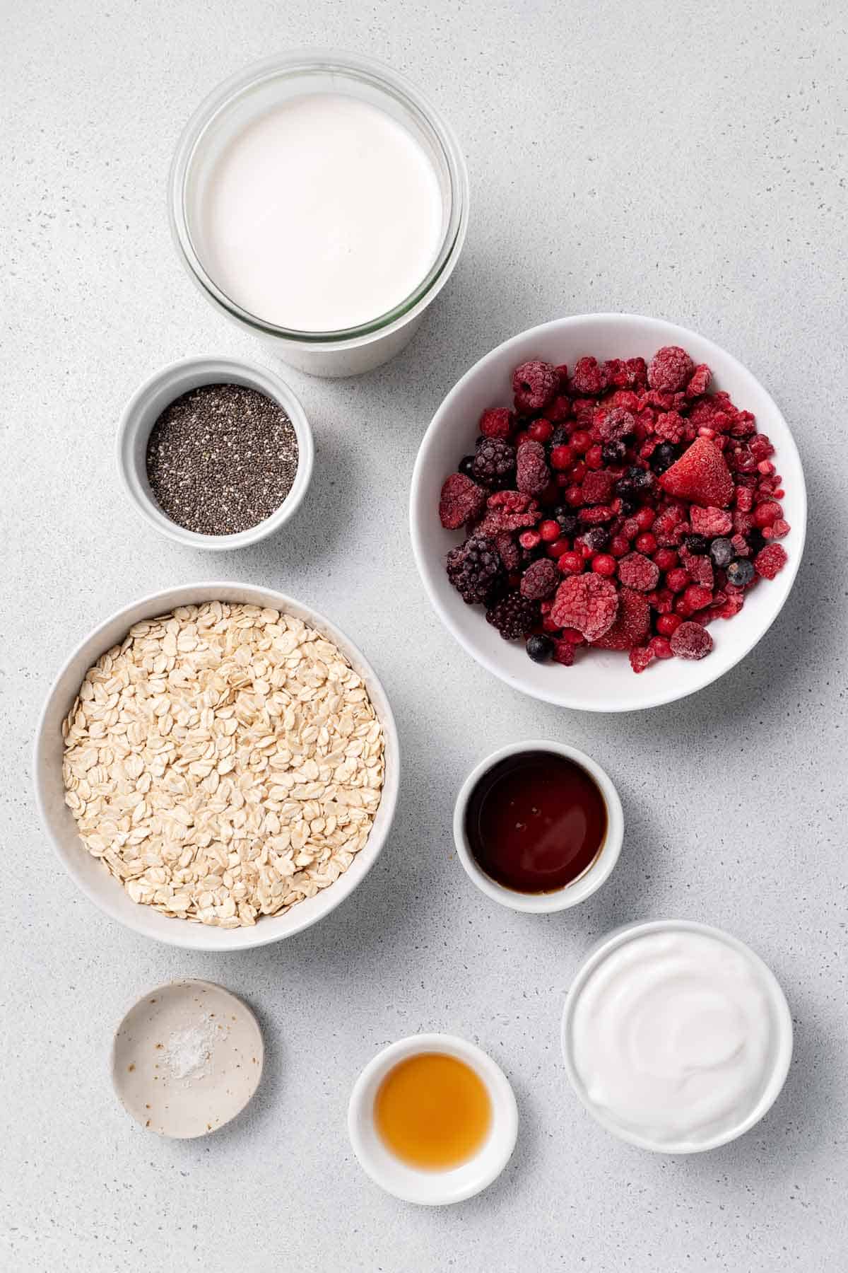 Ingredients needed to make overnight oats with frozen fruit.