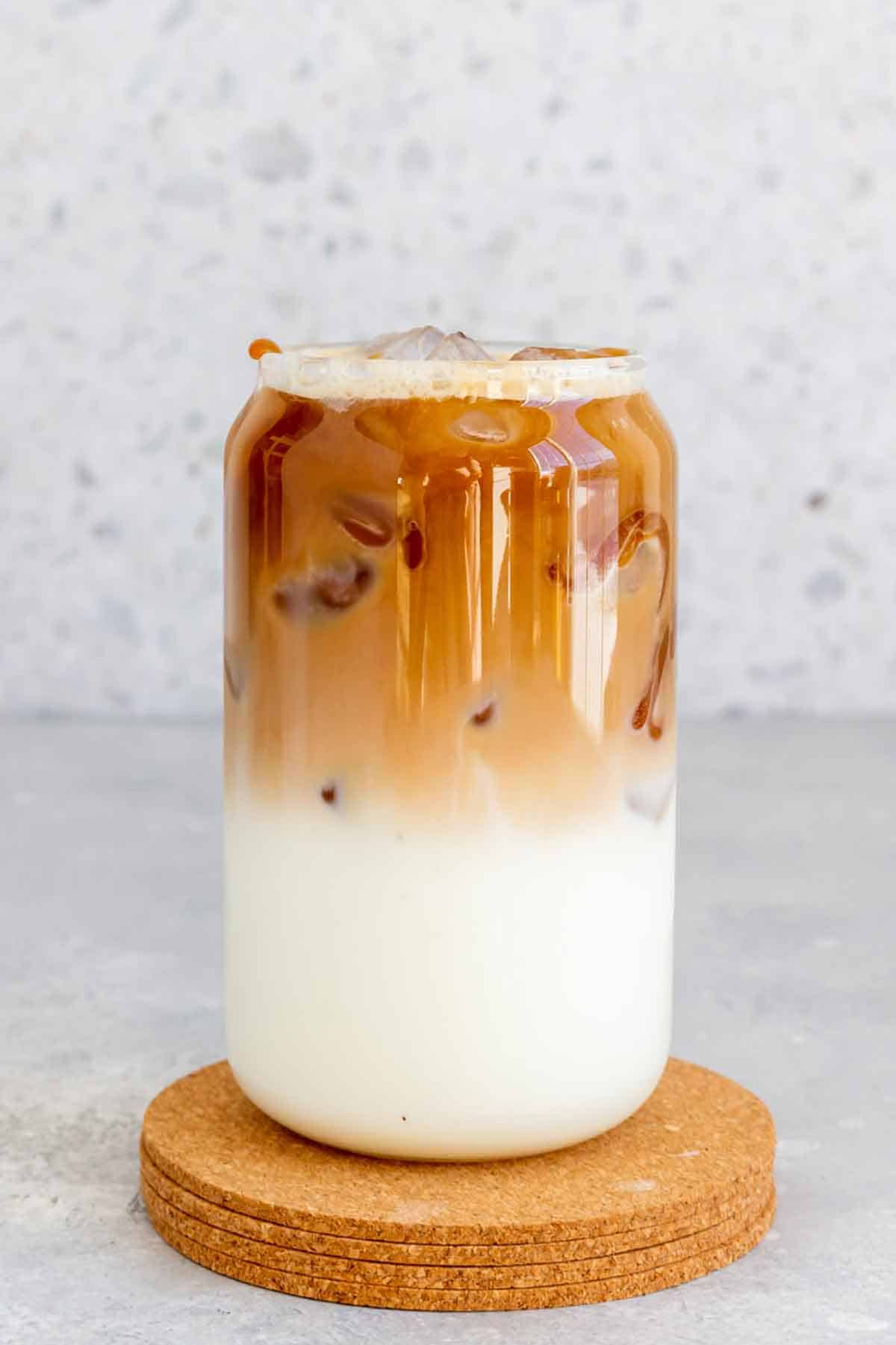 A caramel macchiato in a glass, showing the distinctive layers.