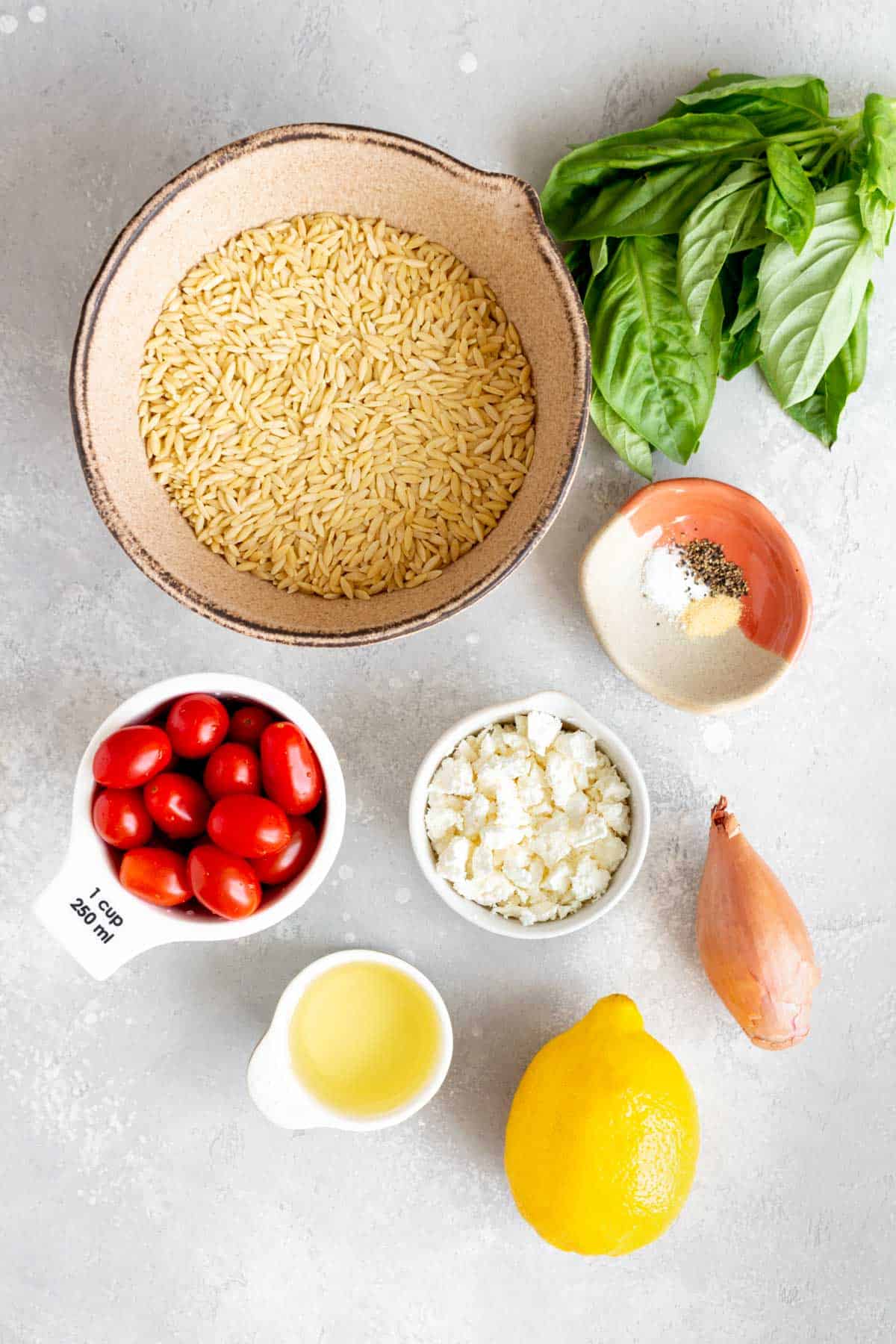 Ingredients needed to make a lemon orzo salad with feta.