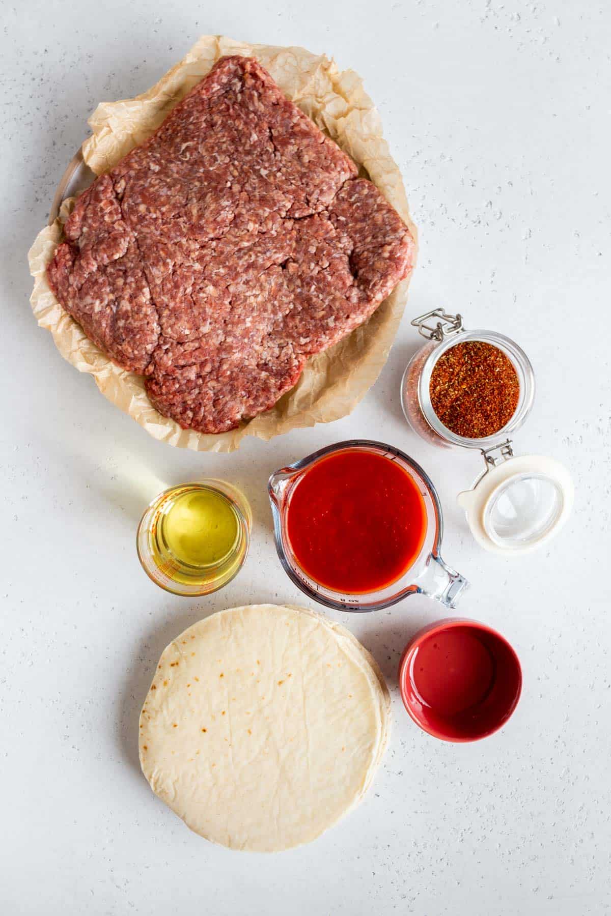 Ingredients needed to make ground beef tacos.