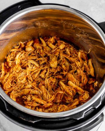 Shredded instant pot bbq chicken in the pressure cooker.