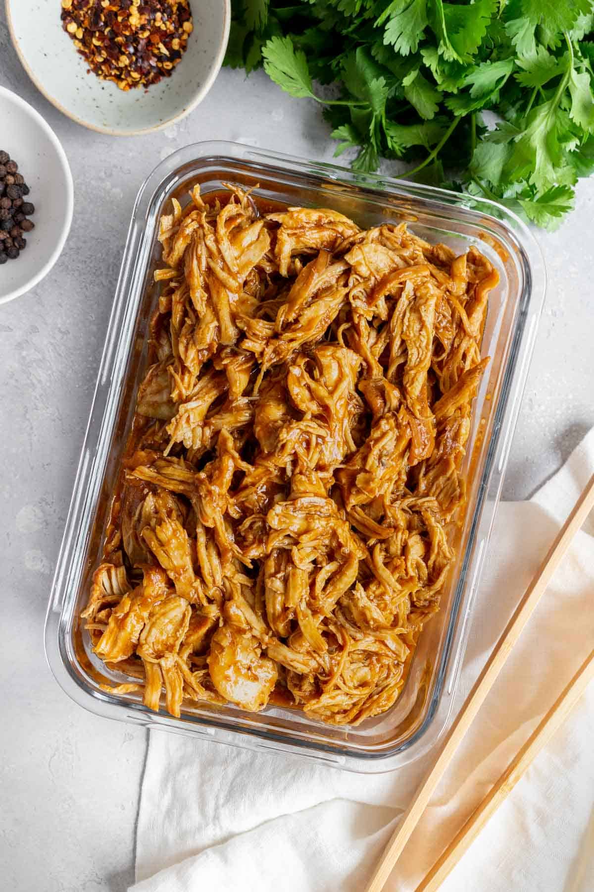 Instant Pot bbq chicken shredded in a meal prep container.
