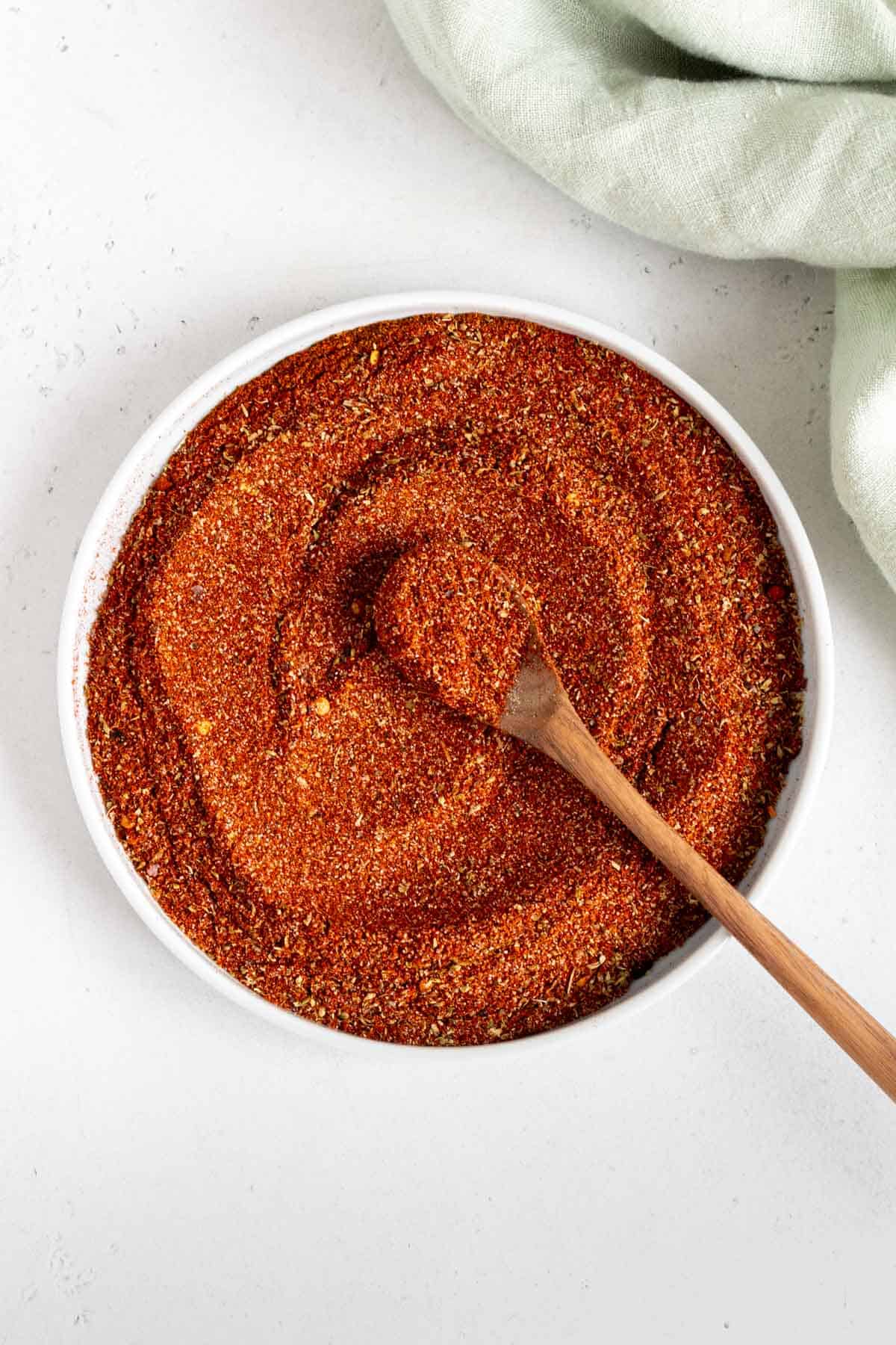 Taco seasoning without salt in a plate, mixed with a spoon.