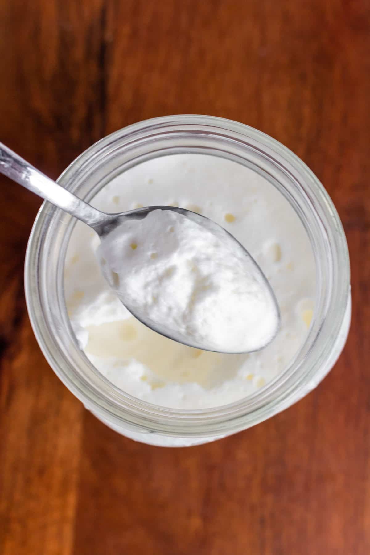 Overhead view of a spoonful of sweet cream cold foam.
