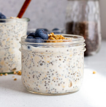 A jar of vanilla overnight oats with another in the back and a jar of chia seeds.