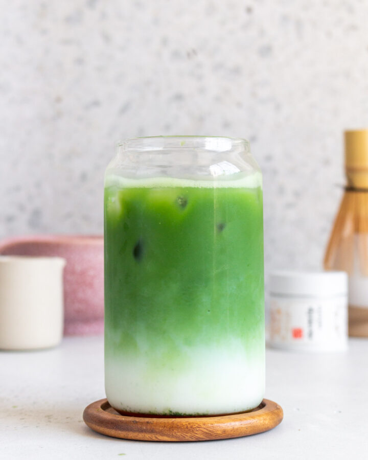 A glass of iced matcha latte with the milk and matcha in distinctive layers.