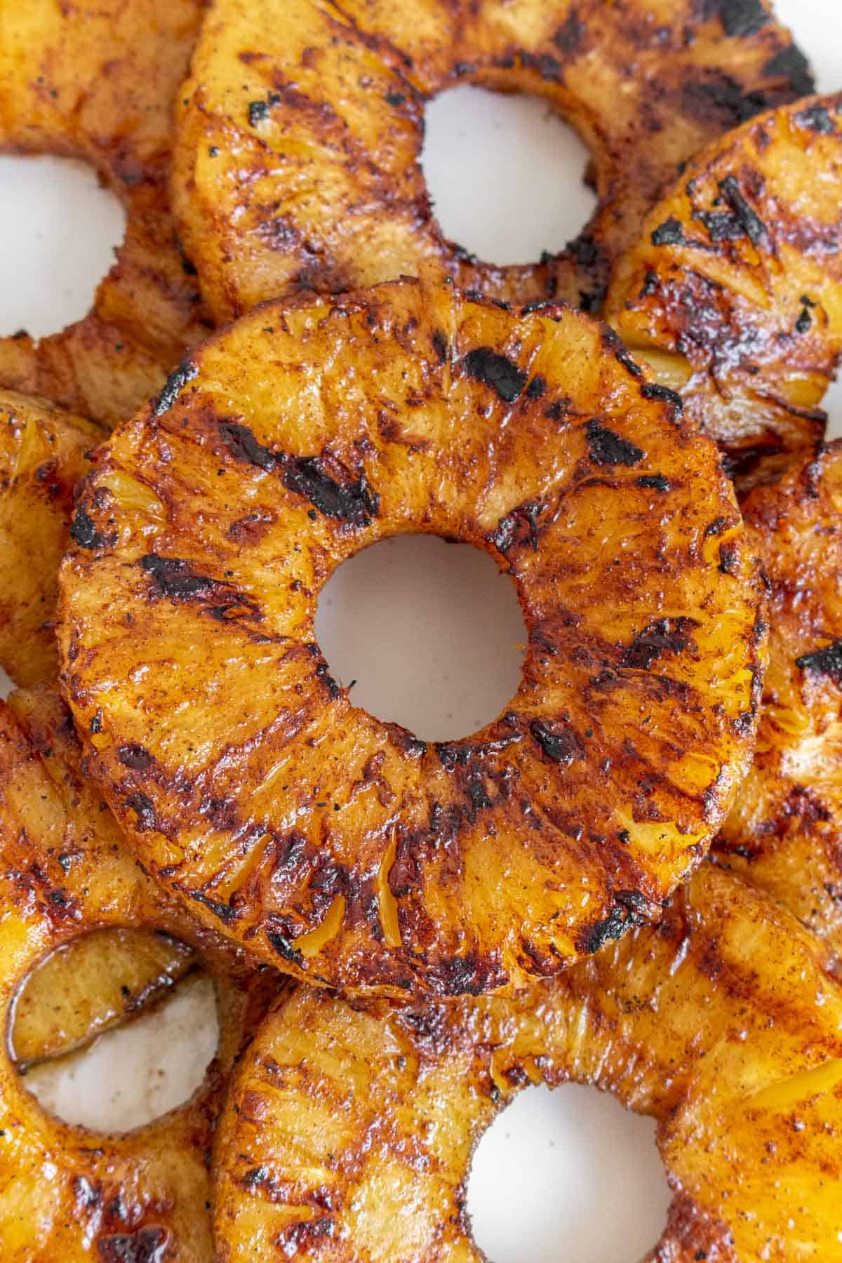 Overhead view of a grilled pineapple ring with grill marks.
