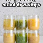 Two rows of three jars of healthy salad dressings.