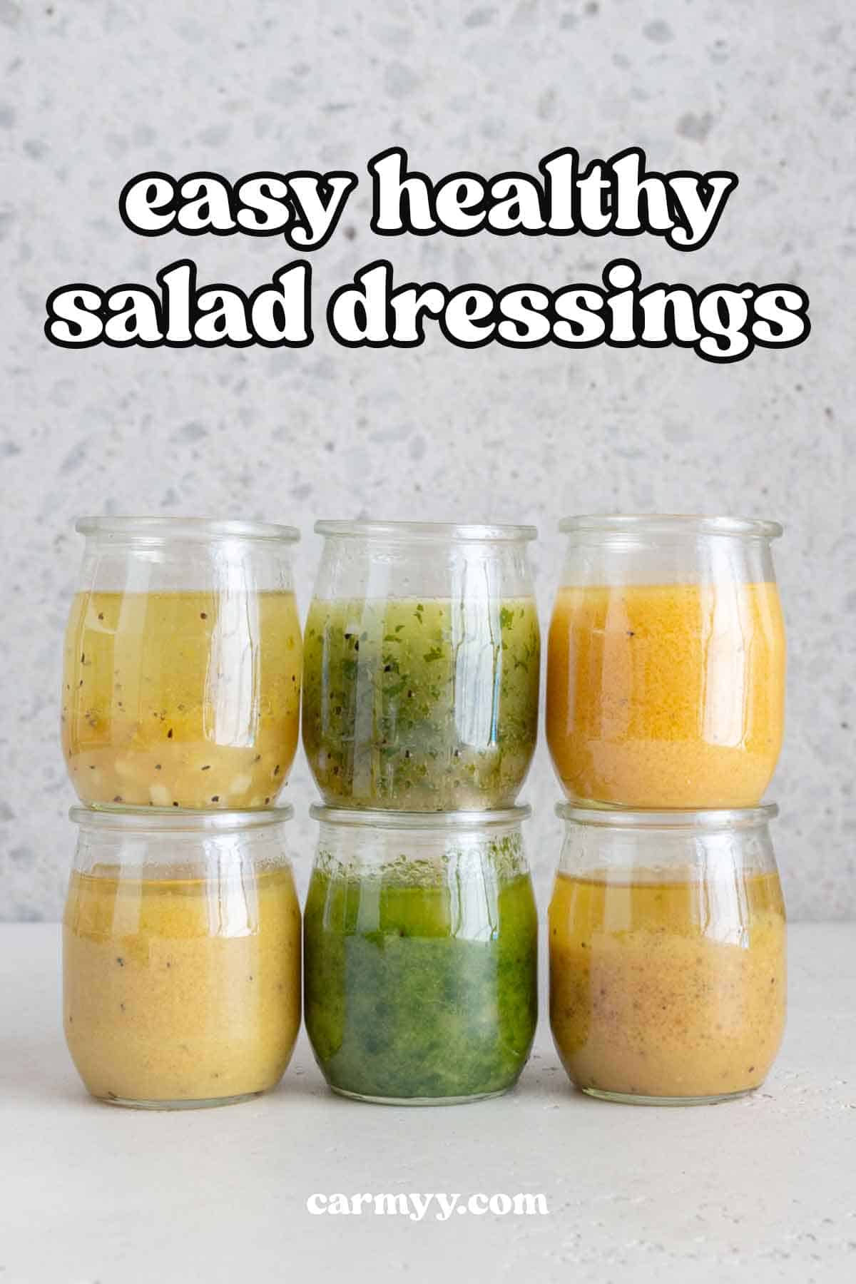Two rows of three jars of healthy salad dressings.