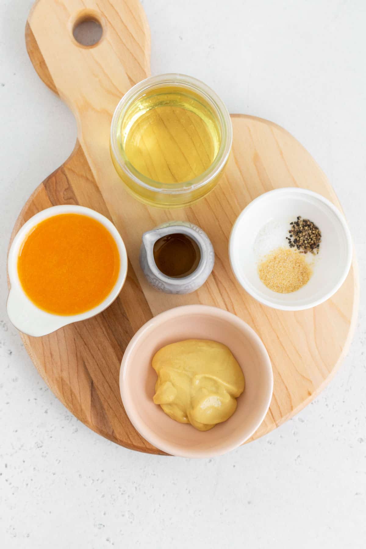 Ingredients needed to make orange mustard dressing.