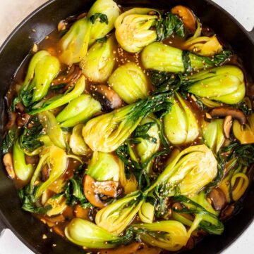 Overhead view of a skillet of bok choy stir fry.