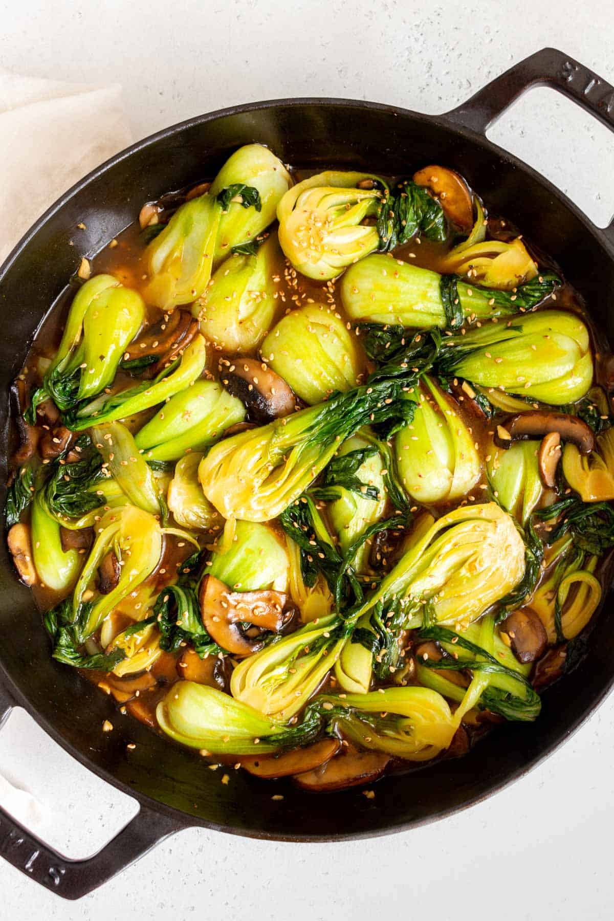 Overhead view of a skillet of bok choy stir fry.